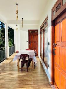 a dining room with a table and a door at Racy Nature Cottage in Ella +74 photos