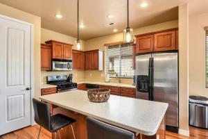 a kitchen with wooden cabinets and a stainless steel refrigerator at Pine Mountain Trail Pool Table Dog Family Fun in Flagstaff in Flagstaff