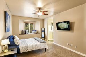 a bedroom with a bed and a ceiling fan at Pine Mountain Trail Pool Table Dog Family Fun in Flagstaff in Flagstaff