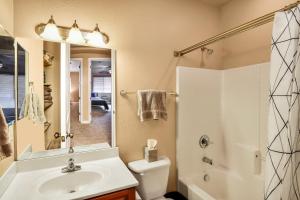 a bathroom with a sink and a toilet and a mirror at Pine Mountain Trail Pool Table Dog Family Fun in Flagstaff in Flagstaff +43 photos