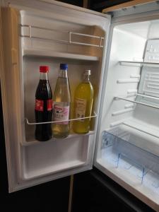a refrigerator with two bottles of drinks in it at Studio am Waldrand in Bad Hersfeld +4 photos