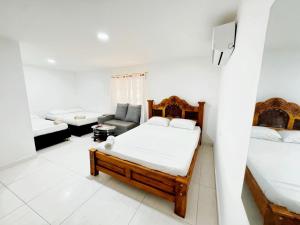 a living room with a bed and a couch at Hotel 7 in Cúcuta