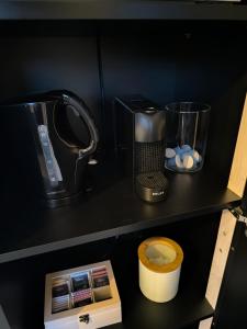 a black shelf with a blender and other items on it at Studio am Waldrand in Bad Hersfeld