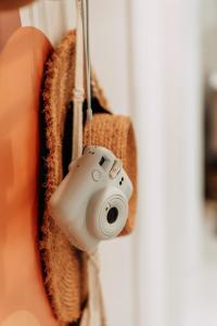 a person holding a camera hanging from a door at Casa Madie - Sea view in Orihuela Costa