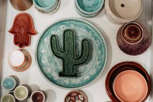 a plate with a cactus on it next to other dishes at Casa Madie - Sea view in Orihuela Costa