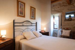 a bedroom with a large white bed with two pillows at Casa do Americano in Vilaboa +60 photos