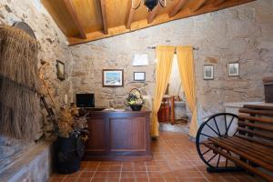 a room with a wooden podium in a stone wall at Casa do Americano in Vilaboa