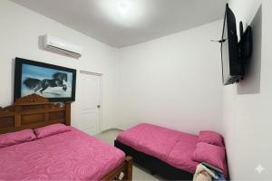 a room with two beds and a tv on the wall at Hotel 7 in Cúcuta +11 photos