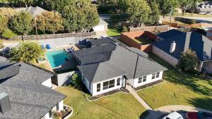 an aerial view of a house with a swimming pool at Homes in Prosper in Prosper