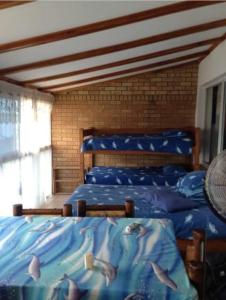 a bedroom with two beds with fish on them at Andante Villas in Kingsburgh