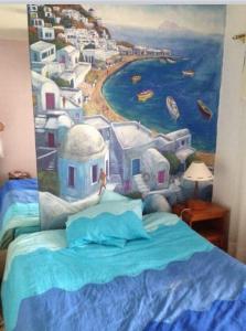 a bedroom with a painting on the wall at Andante Villas in Kingsburgh +1 photo
