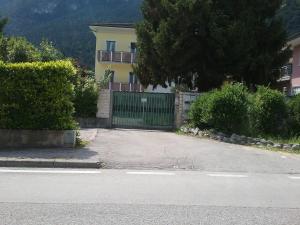 a house with a gate in front of a street at Riva Apartment Negrelli in Riva del Garda +8 photos