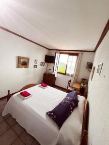 a bedroom with a bed with two pillows on it at Gurbialde Etxea in Mutriku