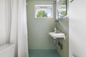 a bathroom with a sink and a mirror at 2502-Nexo-Gubbegardsvejen-31 in Neksø +10 photos