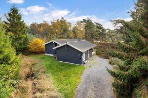 a small house in the middle of a forest at 2502-Nexo-Gubbegardsvejen-31 in Neksø