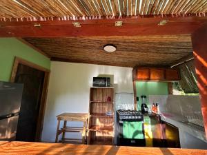 a kitchen with a wooden ceiling and a counter top at Mayara Hostal in El Zonte
