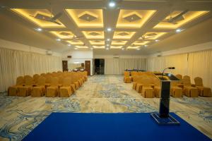 a conference room with chairs and a stage in it at Eeleem Resorts and Spa, Munnar in Anachal