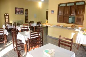 a restaurant with tables and chairs and a counter at Atlântico Amazônia Hotel in Salinópolis