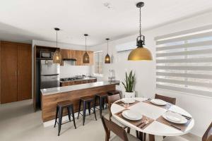 a kitchen and dining room with a table and chairs at Centrally located and comfortable apartment! in Cabo San Lucas