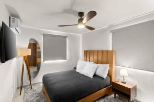 a bedroom with a bed and a ceiling fan at Centrally located and comfortable apartment! in Cabo San Lucas +6 photos