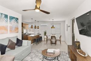 a living room with a couch and a table at Centrally located and comfortable apartment! in Cabo San Lucas