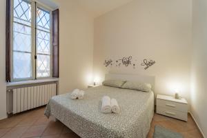 a bedroom with a bed with white shoes on it at La Terrazza in Centro Storico - Free Wifi & AC in Savigliano