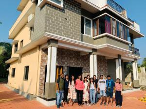 a group of people standing in front of a house at Mystique Copper Smart Villa in Sadāshivgarh