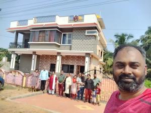 a group of people standing in front of a house at Mystique Copper Smart Villa in Sadāshivgarh +9 photos