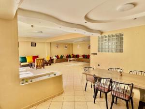 a lobby with a table and chairs and a couch at Luxury apartment with garden view in Agadir
