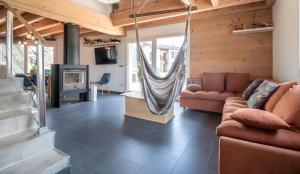 a living room with a couch and a hammock at Chalet d'Aussois Lerovi in Aussois