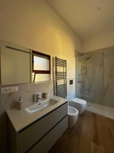 a bathroom with a sink and a toilet and a shower at Angolo Di Mare in Genova +24 photos