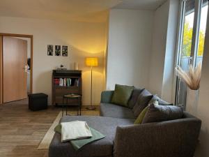a living room with a couch and a table at Apartment London in Bergen an der Dumme