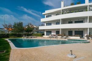 a swimming pool in front of a building at Rooftop Alvor Apartment by Moje Holiday in Alvor