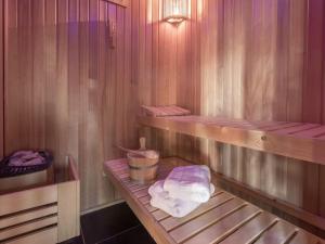 a sauna with a towel sitting on a shelf at Sagard - Ferienhaus Rubin in Sagard +26 photos