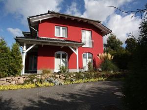 a red house with a black roof at Sagard - Ferienhaus Rubin in Sagard