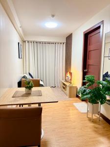a living room with a table and some plants at Rafaels Staycation at Arezzo in Davao City +15 photos