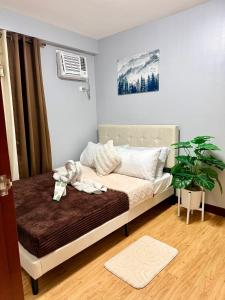 a bedroom with a bed with a stuffed animal on it at Rafaels Staycation at Arezzo in Davao City