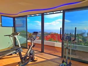 a gym with two exercise bikes in front of a window at Skyline Home Funchal in Funchal