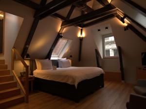 a bedroom with a large bed in a attic at Swissôtel Amsterdam in Amsterdam