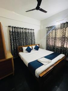 ビサーリーにあるVythiri saara innのベッドルーム1室(ベッド1台、シーリングファン付)
