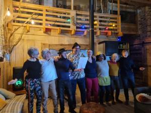 a group of people posing for a picture in a living room at La Maison Mescladis in Manhac