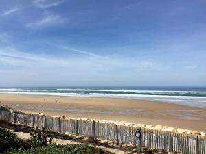 a view of a beach with people walking on the sand at Suite Majorelle du Château in Gaillan-en-Médoc