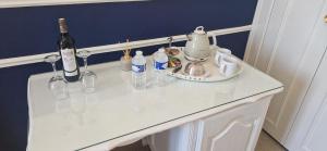 a white table with wine bottles and glasses on it at Suite Majorelle du Château in Gaillan-en-Médoc