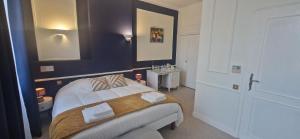 a bedroom with a bed and a sink in it at Suite Majorelle du Château in Gaillan-en-Médoc