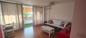 a living room with a couch and a table at Flamingo Palmar in Palm-Mar