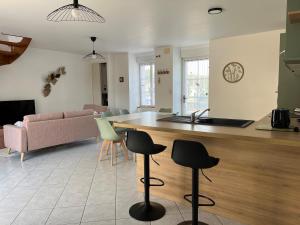 a kitchen and living room with a table and chairs at Maison Centre Ville - Saint-James in Saint-James
