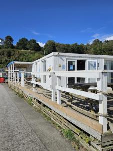 a row of white mobile homes sitting on a fence at Millendreath Oean View Villa in Saint Martin