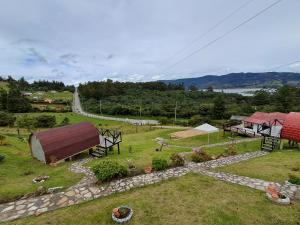 an aerial view of a farm with a house and a field at Suit Encanto Dorado in Guatavita
