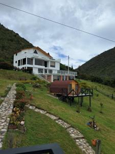 a house on the side of a hill at Suit Encanto Dorado in Guatavita