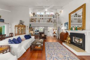 a living room with a white couch and a fireplace at The Turtle Nest in Sanibel